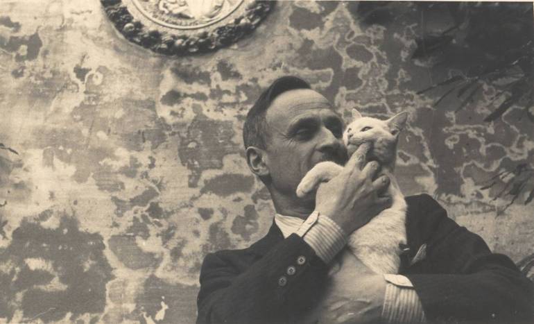 Marino Moretti negli anni '40 nel giardino con il gatto